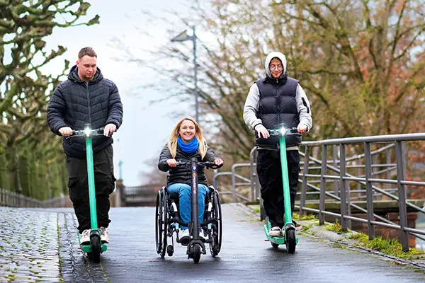 Empulse F35 being used by a woman alongside two men on scooters